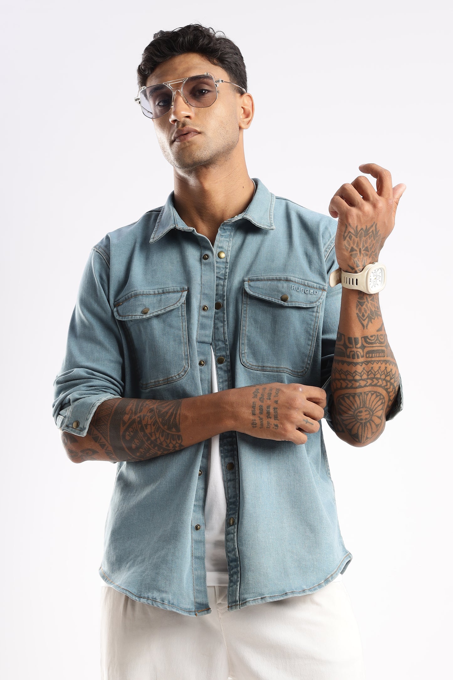 Model wearing Skybound Indigo denim shirt styled with rolled-up sleeves for a relaxed look