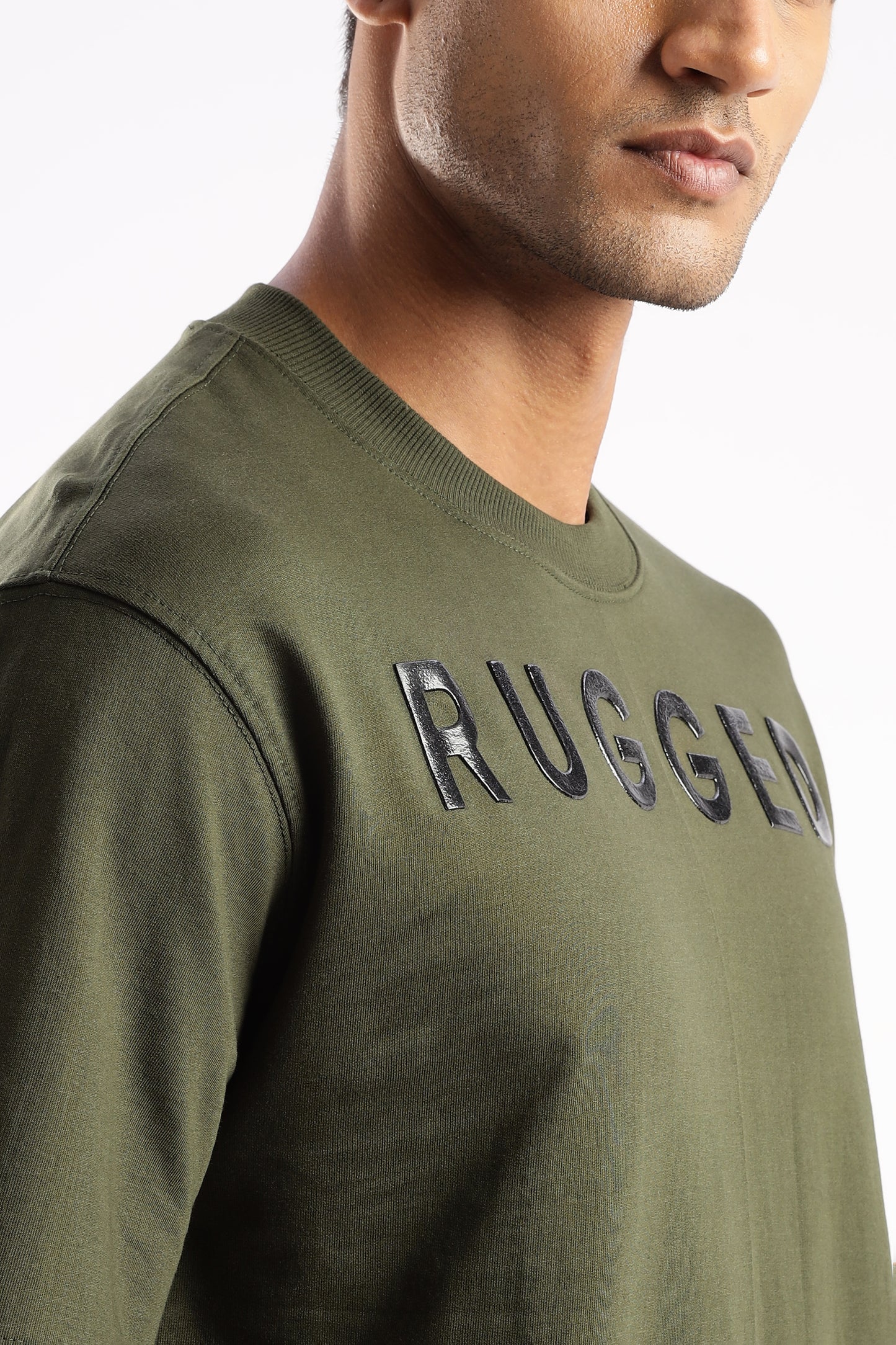 Close-up of Evergreen Mist tee showing soft bio-washed cotton texture and chest logo
