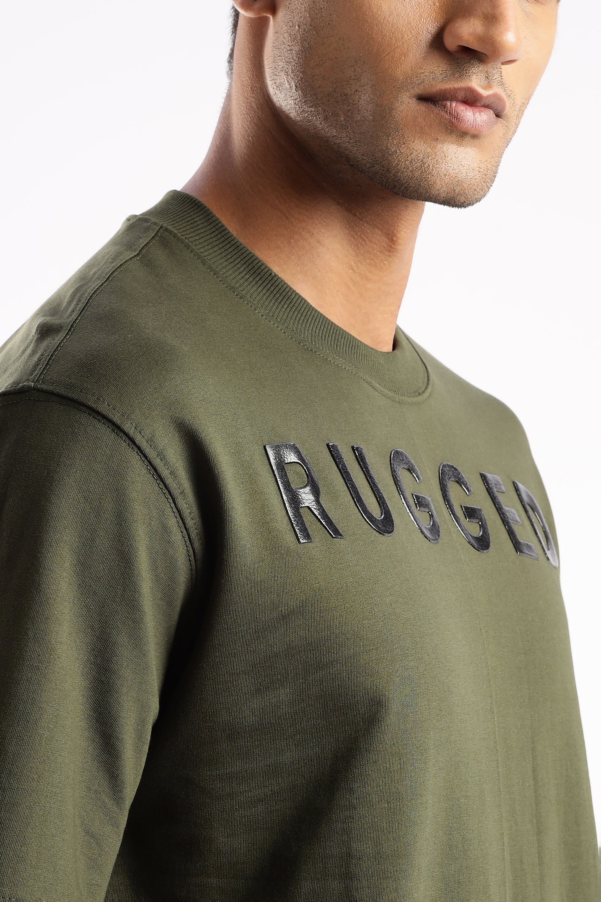 Close-up of Evergreen Mist tee showing soft bio-washed cotton texture and chest logo