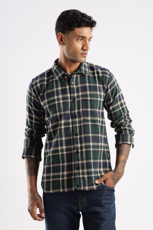 Model wearing Explorer Flannel Shirt in Forest Canopy green check pattern with chest pockets