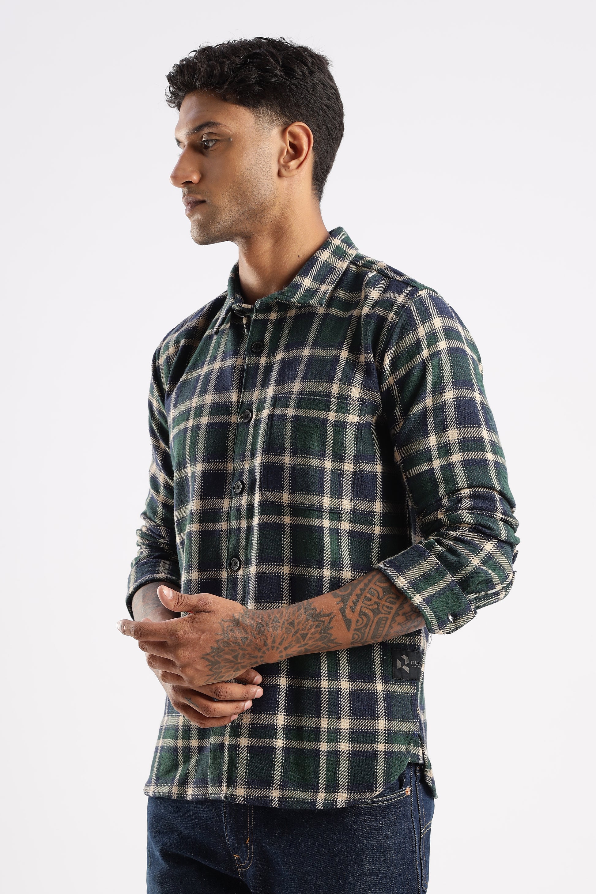 Outdoor lifestyle shot of model wearing Forest Canopy flannel shirt in natural setting