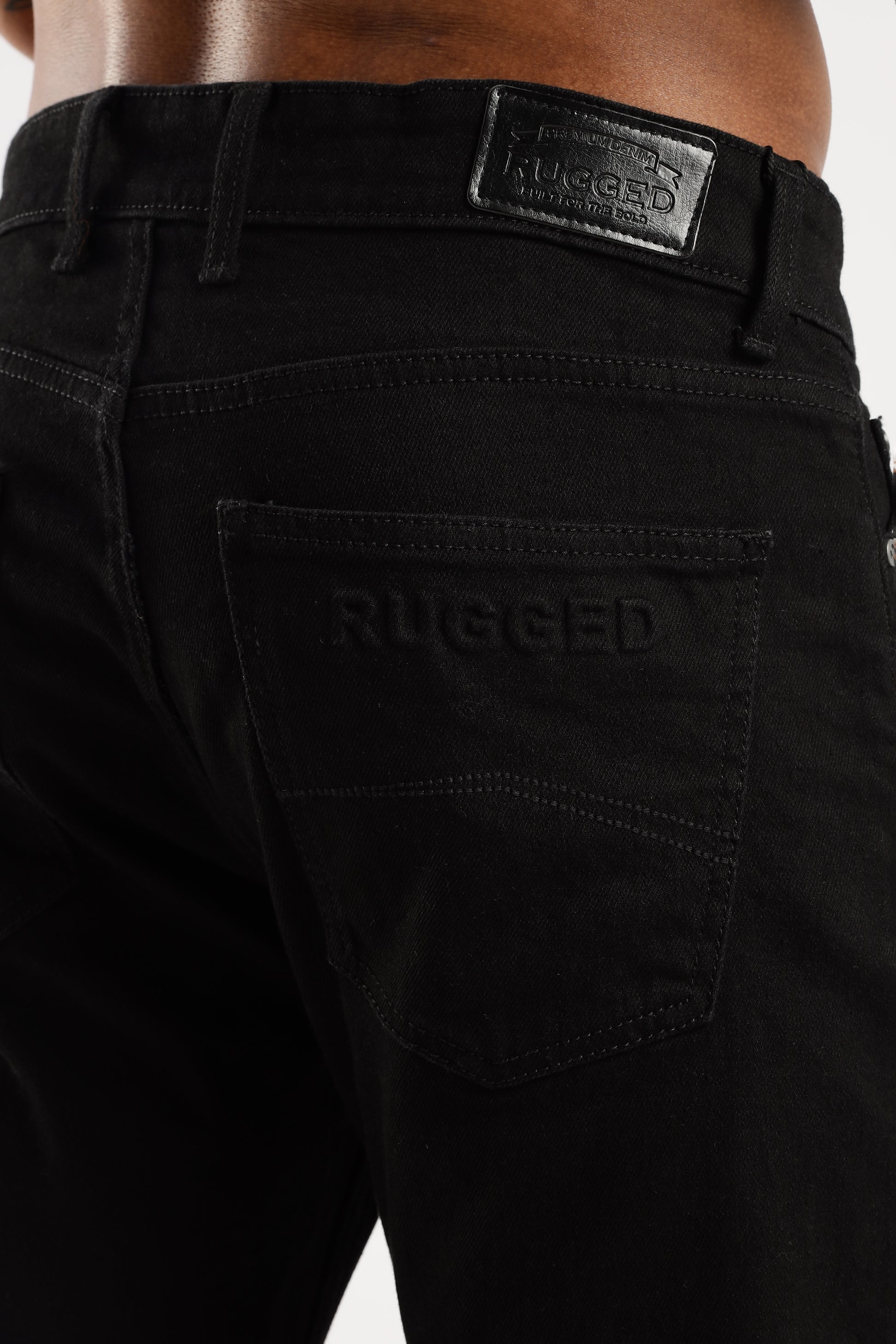 Close-up of Shadow Trail denim showing twill weave texture and reinforced stitching