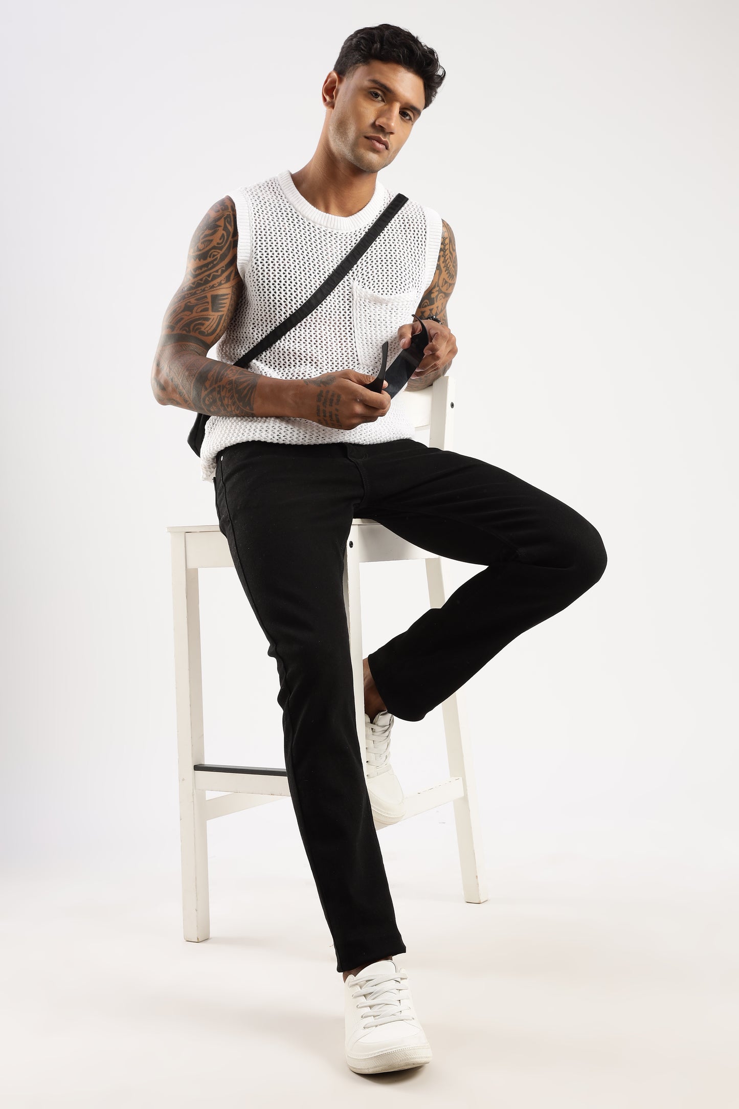 Model showcasing Sleek Tapered Fit Jeans in Shadow Trail with urban rugged look