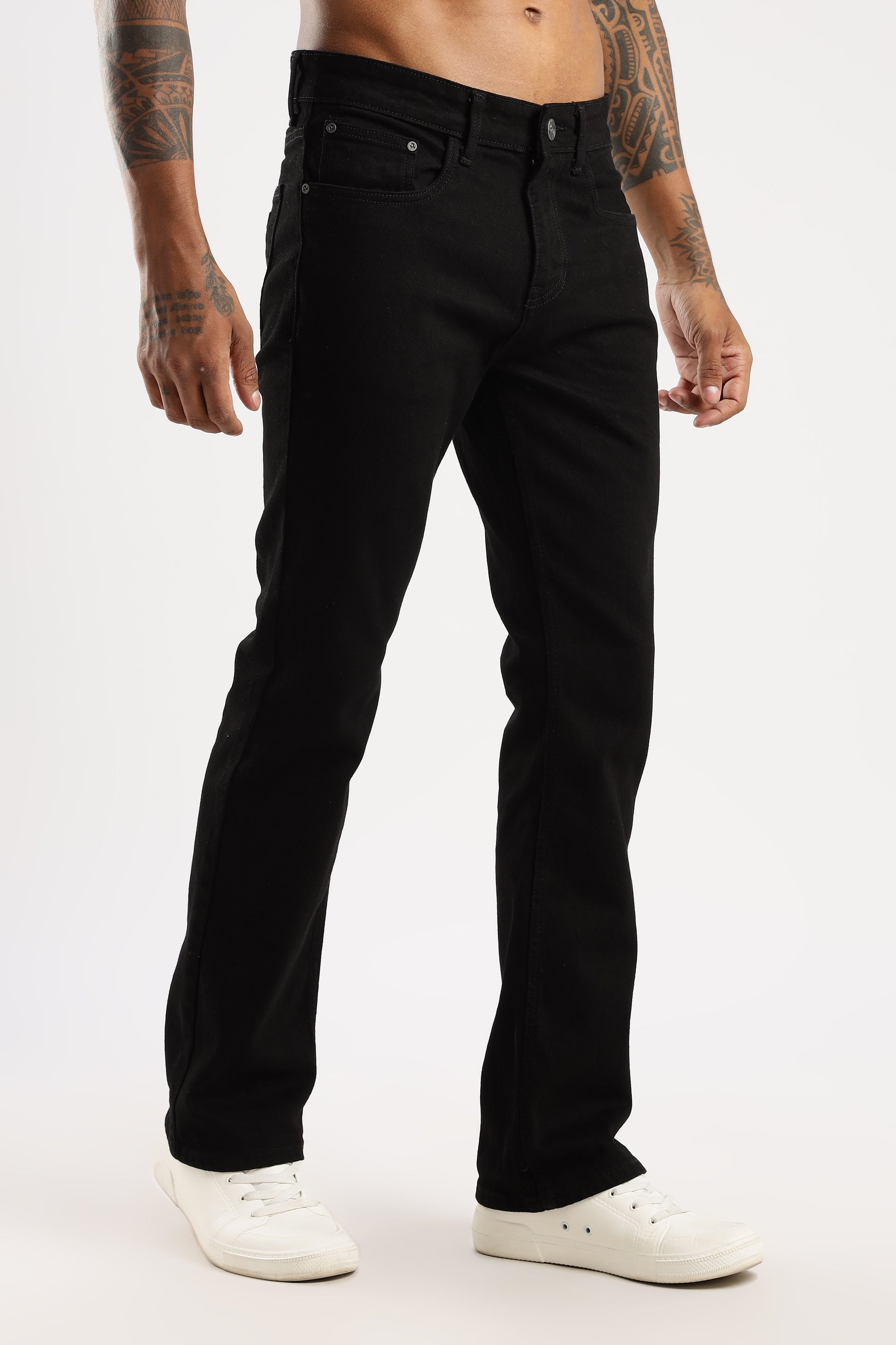 Model walking outdoors in Shadow Trail Sleek Bootcut Fit Jeans with relaxed flare