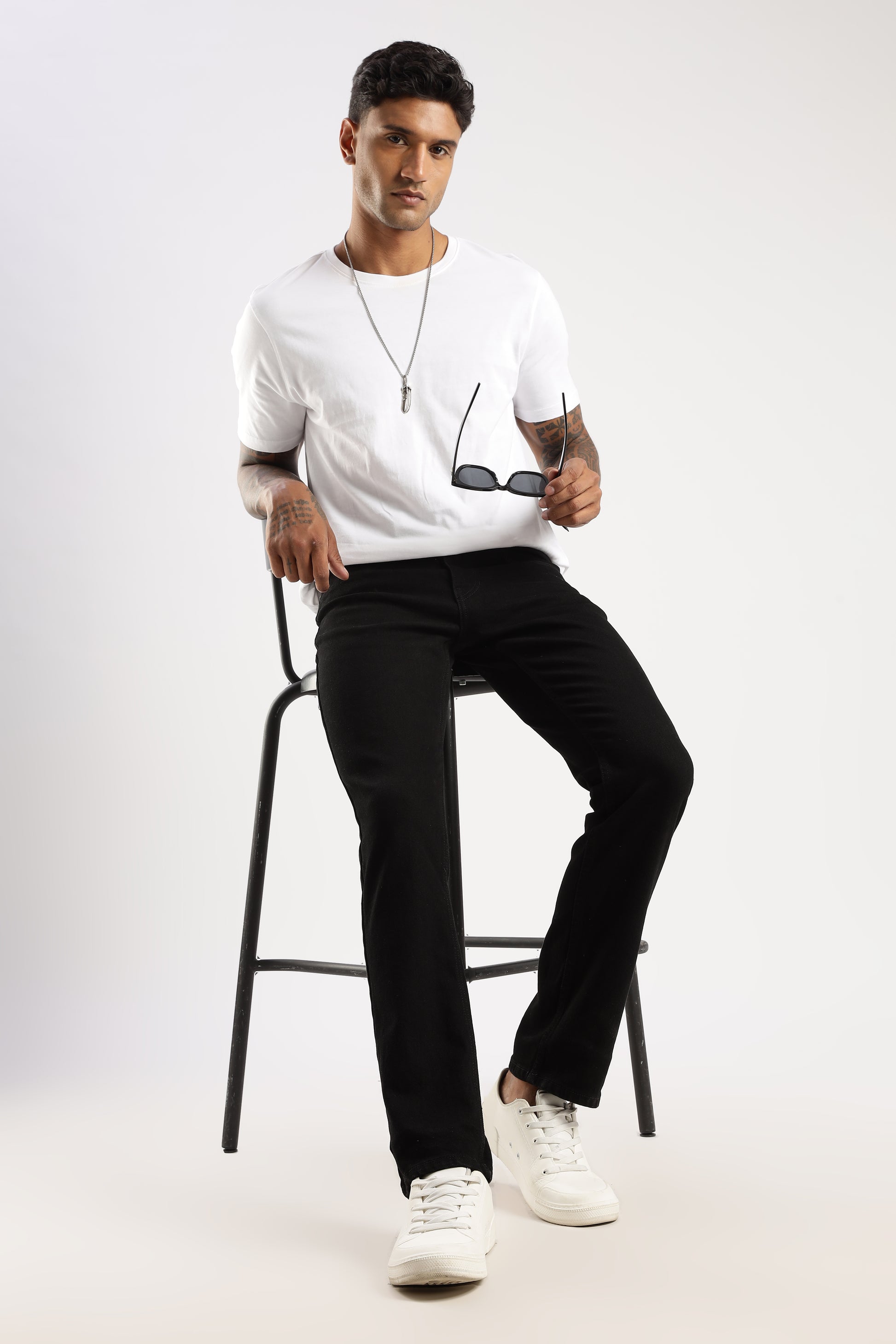 Model walking outdoors wearing Sleek Straight Fit Jeans Steel Wave with straight leg design