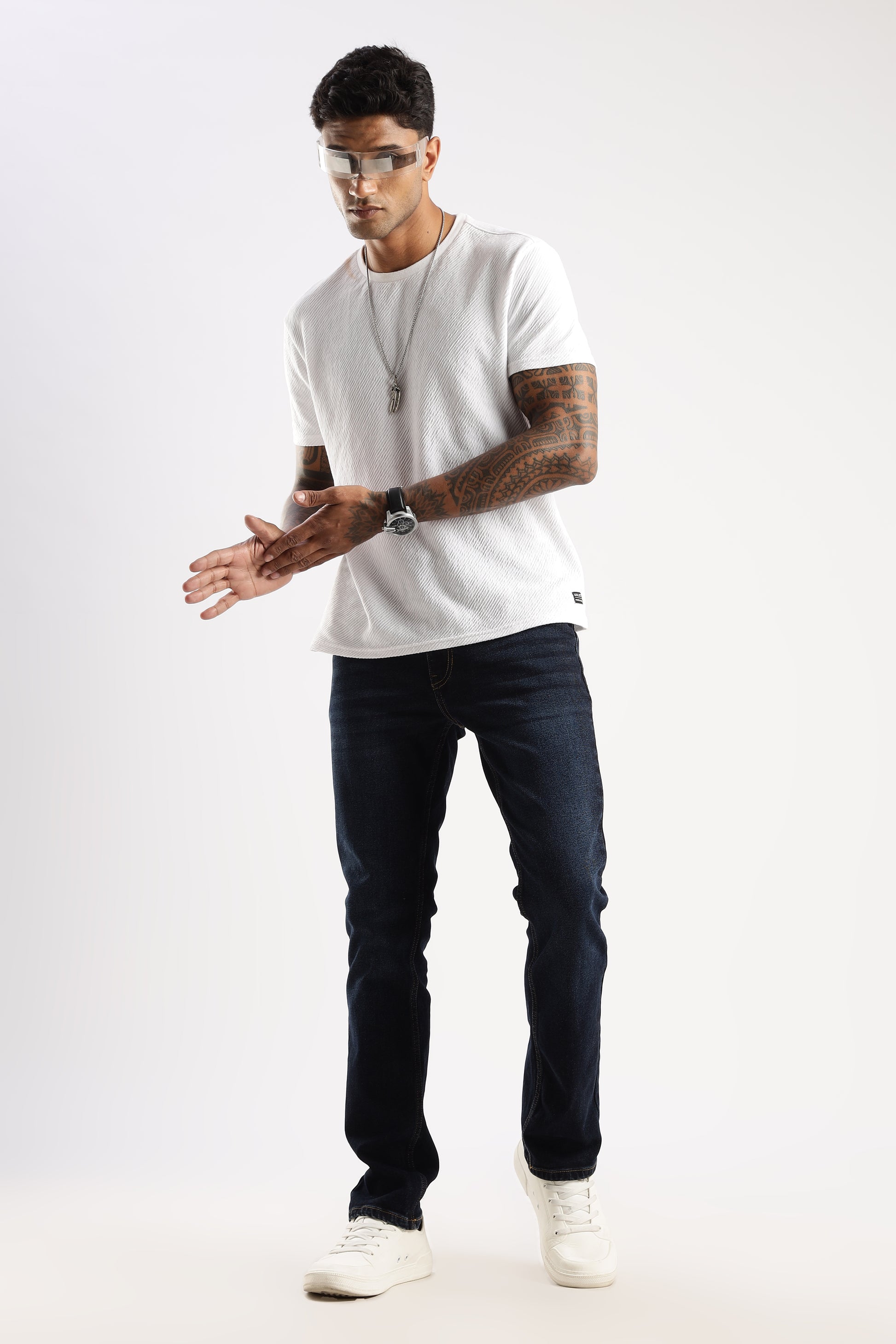 Lifestyle shot of model walking in Steel Wave straight fit jeans paired with a crew neck tee