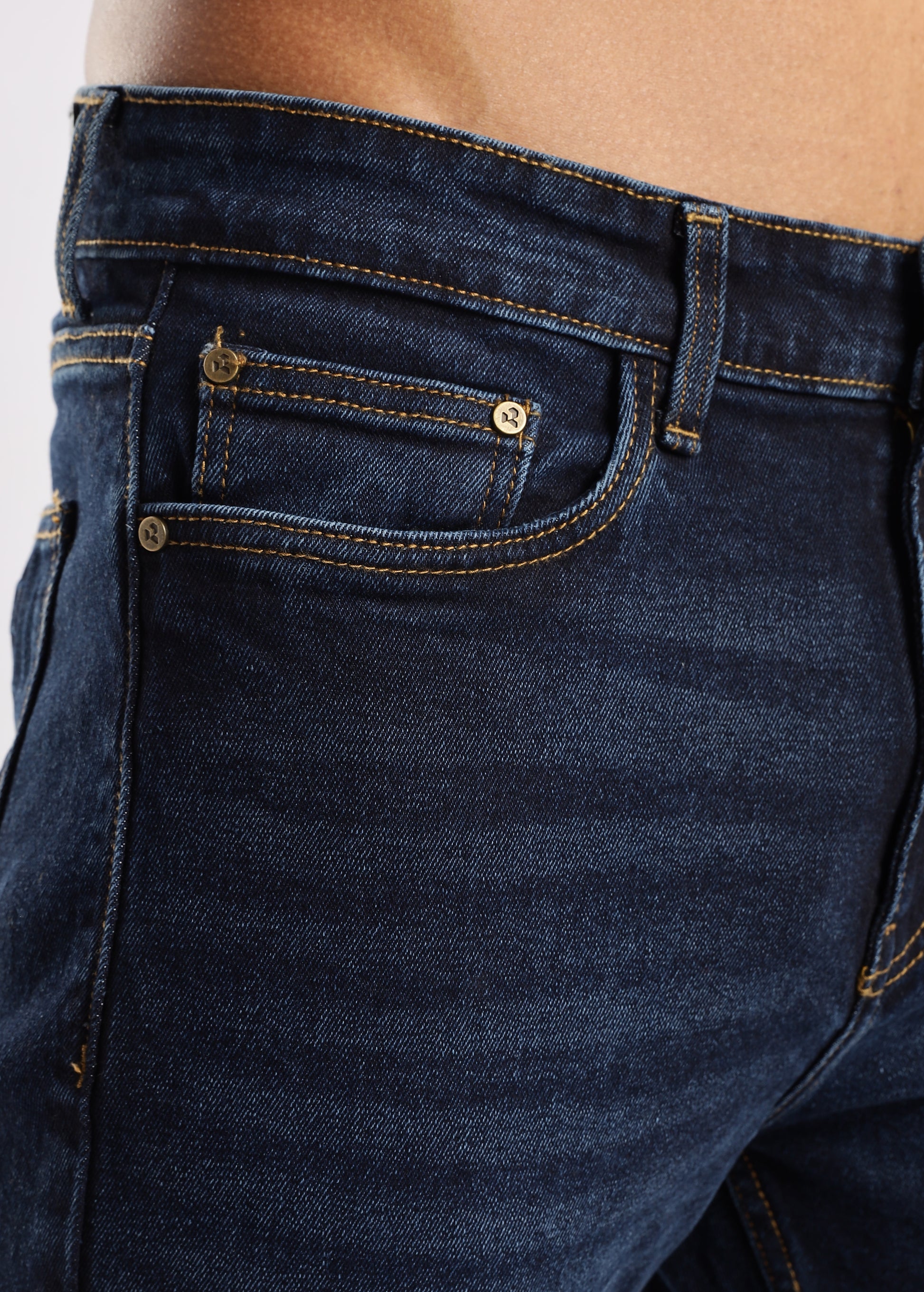 Men’s tapered jeans in Steel Wave wash paired with boots and layered tee