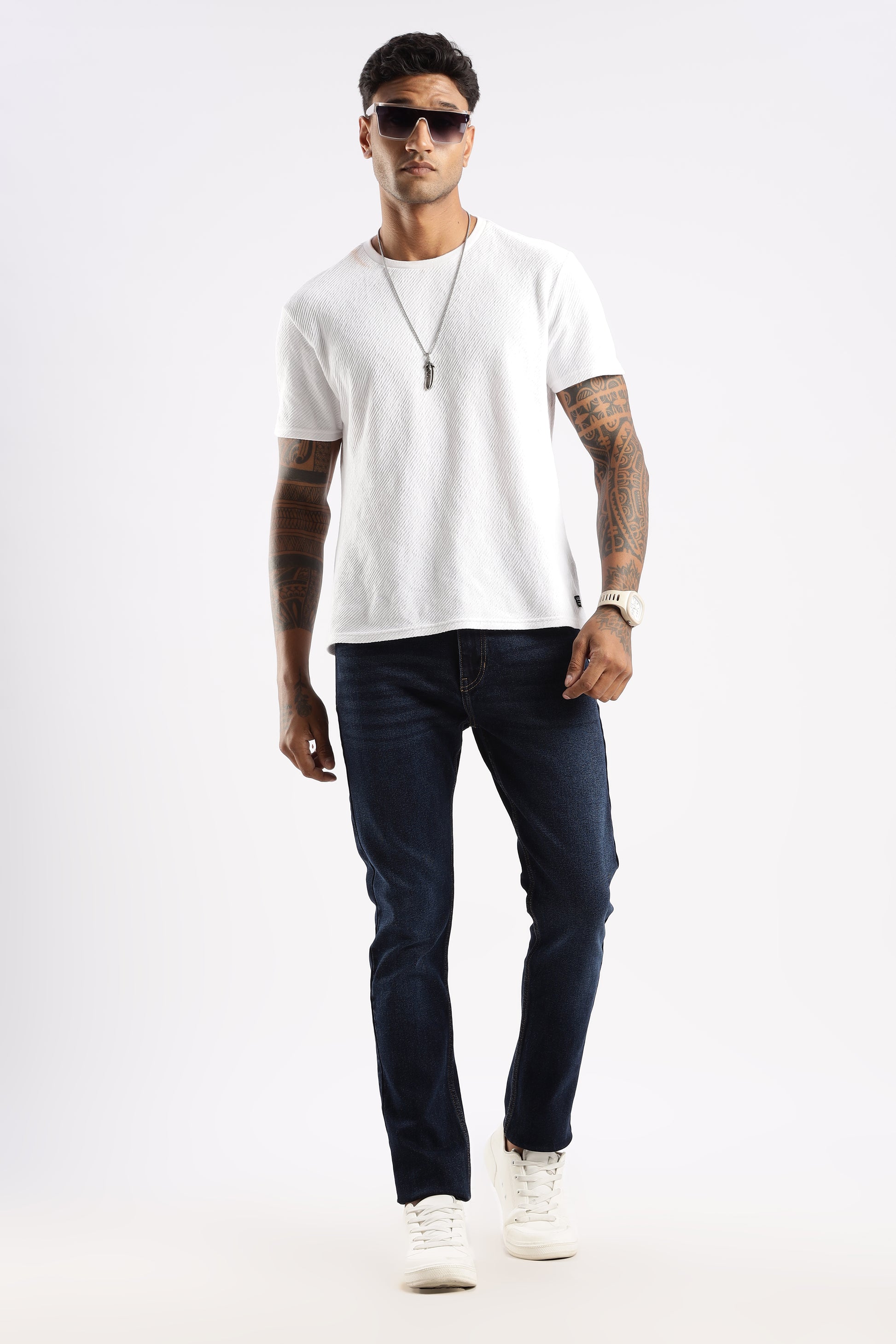 Flat lay of Steel Wave tapered denim jeans with structured leg and clean hem