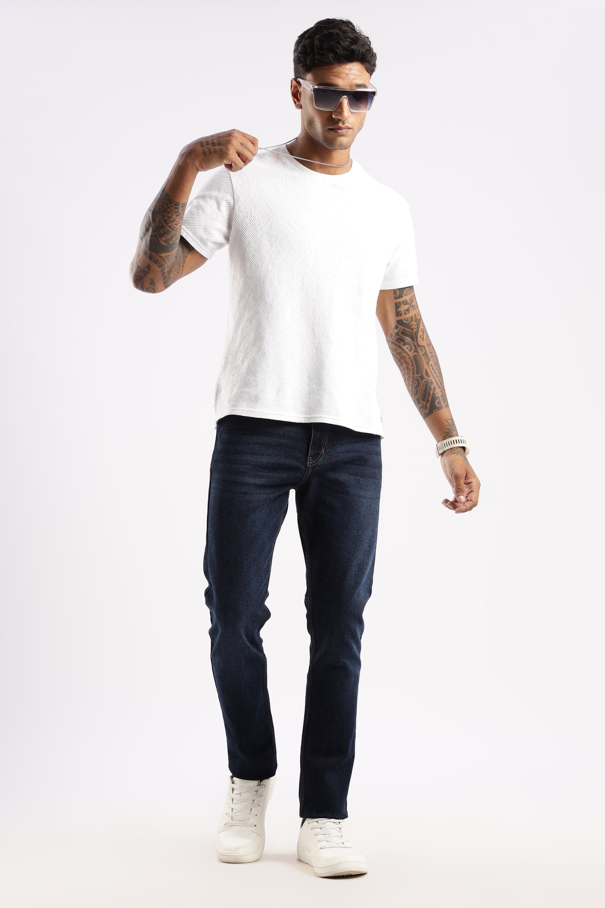 Lifestyle shot of model walking in Steel Wave jeans, styled for rugged minimalism