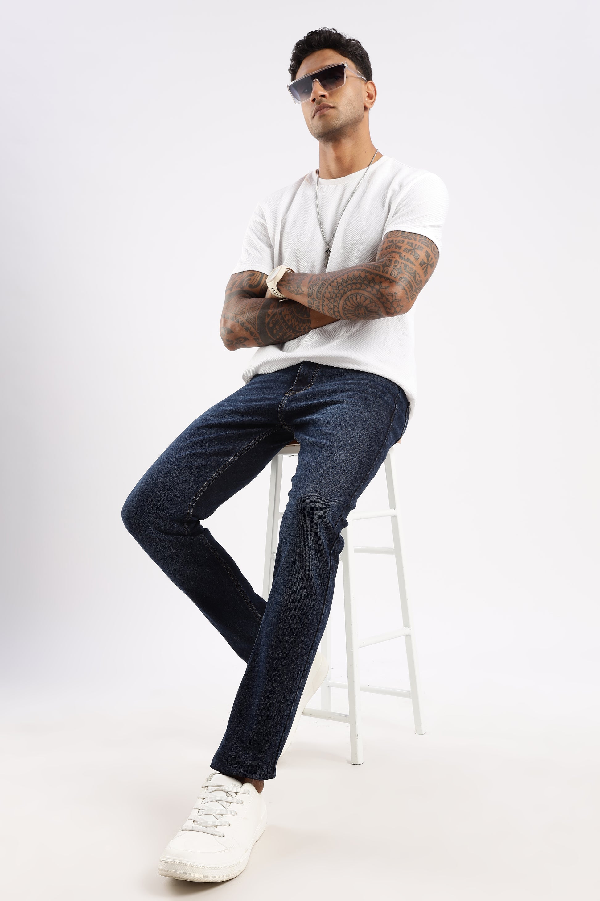 Men’s tapered jeans in Steel Wave wash paired with boots and layered tee